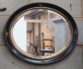 An painted gilt framed oval mirror, width 60cm, height 50cm